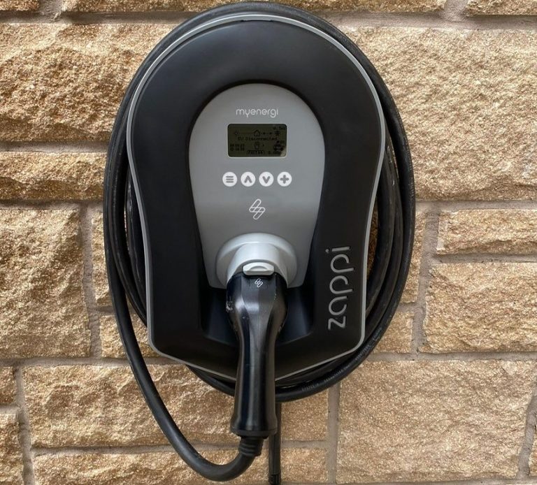 Black and grey zappi branded Electrical Vehicle (EV) charging point fitted by KF Watson mounted on an external wall