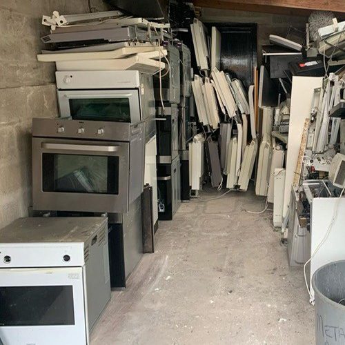 Old electrical equipment (including ovens) stored ready for collection and recycling